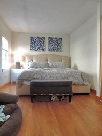 1-4 Schrepel Place Boston, MA 02127 - Photo 6 of 13 a bedroom with a bed couch and window