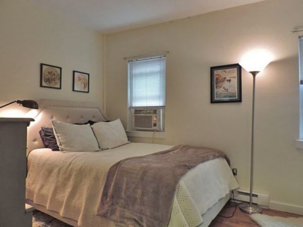 1-4 Schrepel Place Boston, MA 02127 - Photo 8 of 13 a bedroom with a bed and painting on the wall