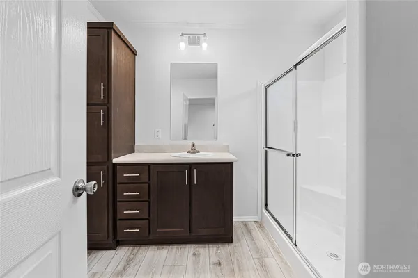 a bathroom with a sink vanity and a mirror