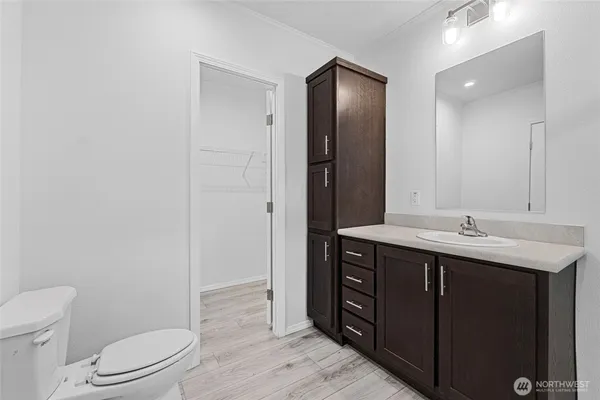 a bathroom with a toilet a sink and mirror
