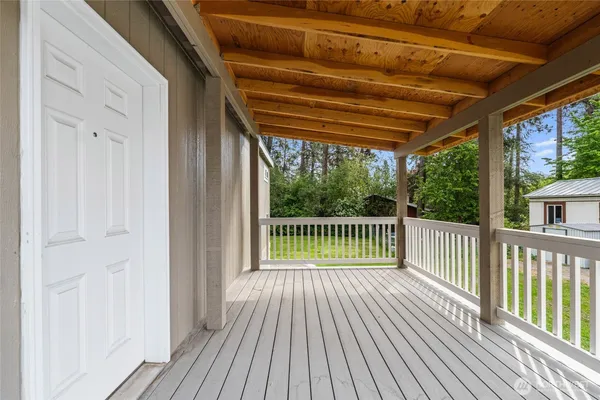 a view of a balcony with wooden floor