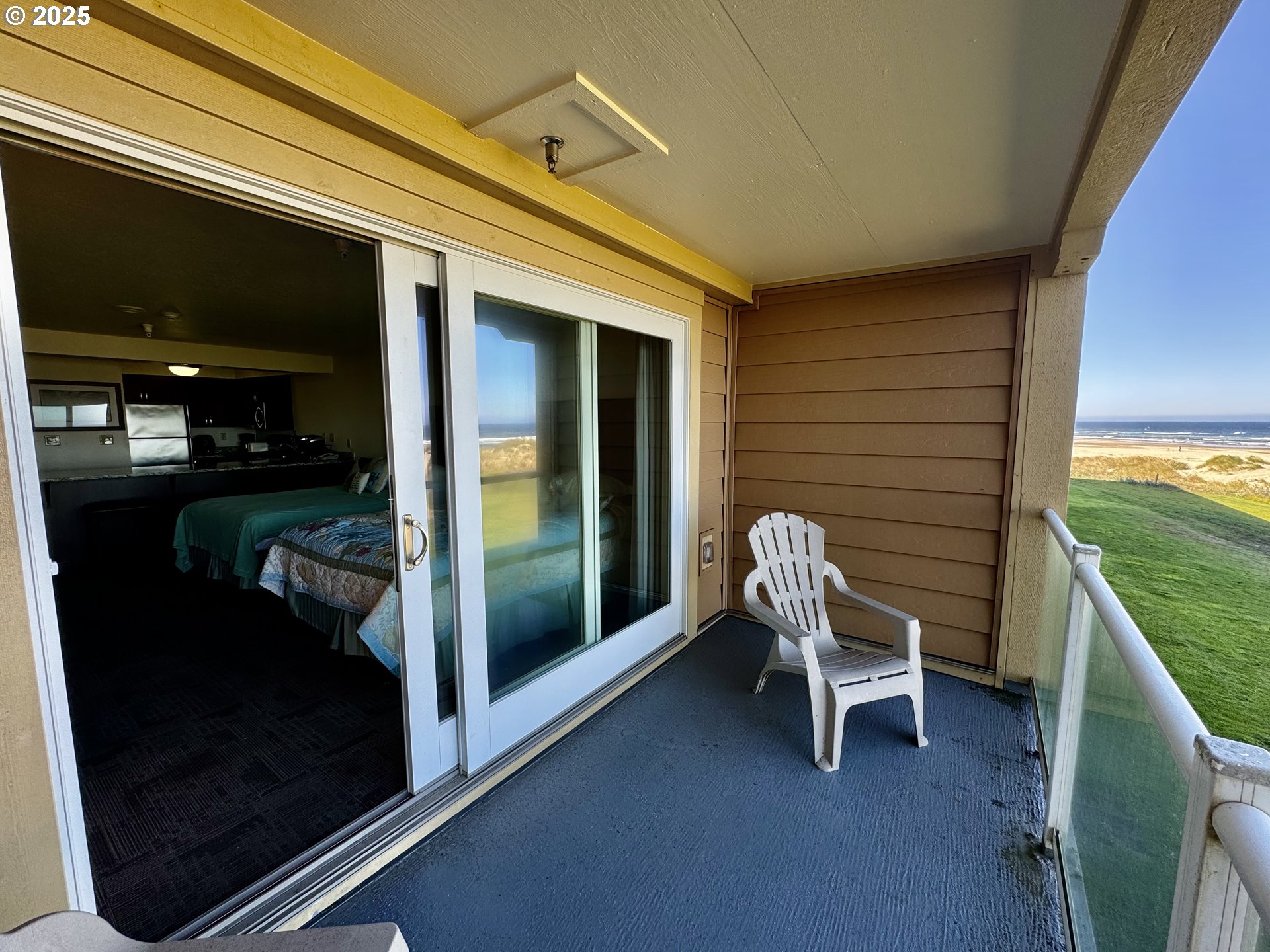 88416 1st Avenue, Unit 201 Florence, OR 97439 - Photo 1 of 29 a balcony with chairs and a gate