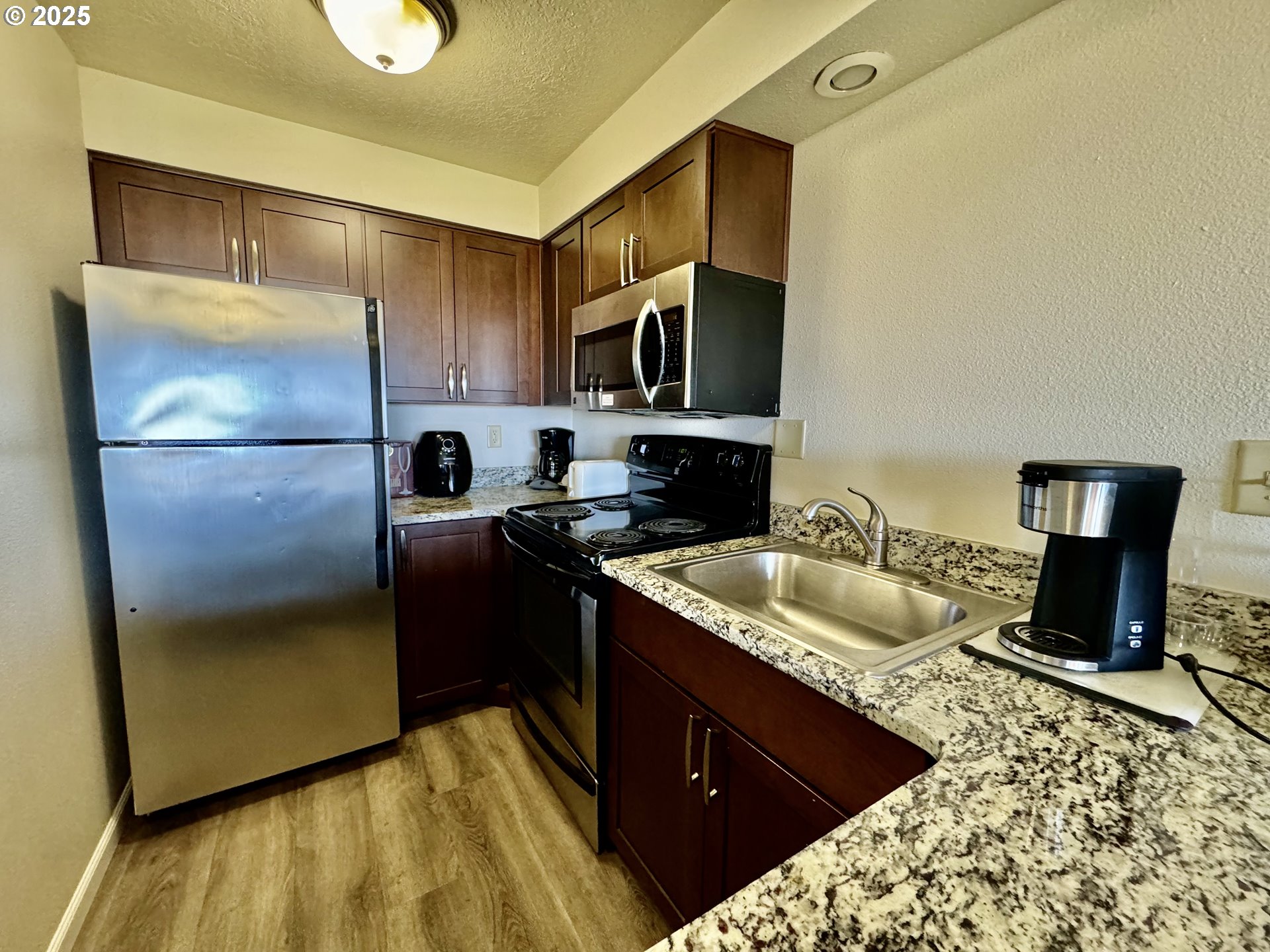88416 1st Avenue, Unit 201 Florence, OR 97439 - Photo 5 of 29 a kitchen with a refrigerator sink and stove