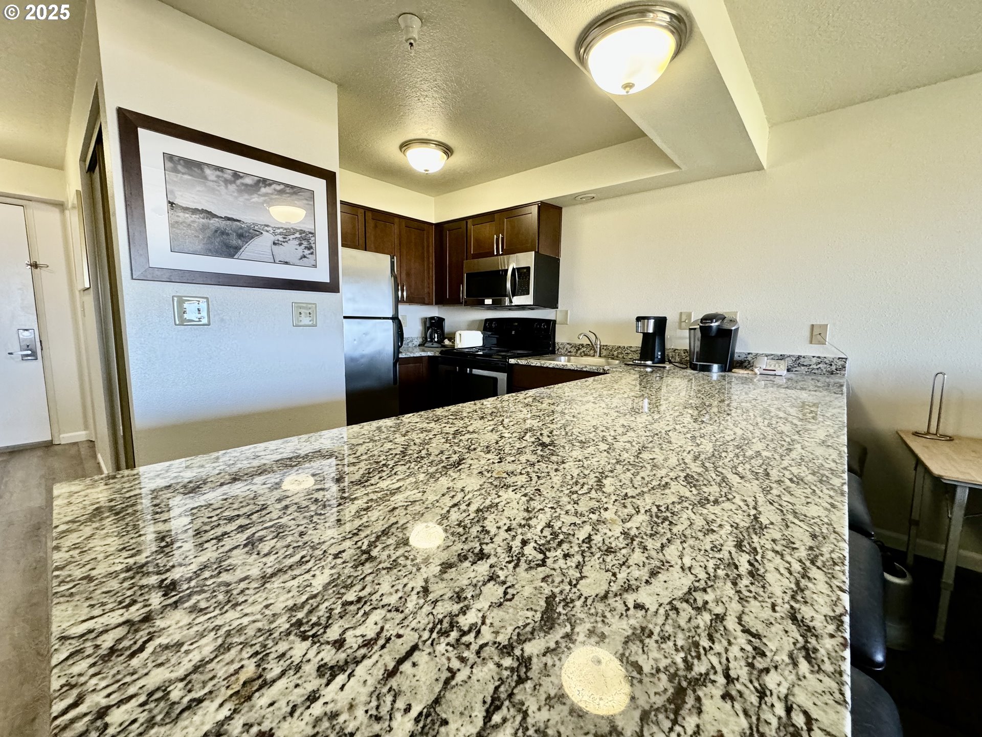 88416 1st Avenue, Unit 201 Florence, OR 97439 - Photo 7 of 29 a bedroom with furniture and a flat screen tv