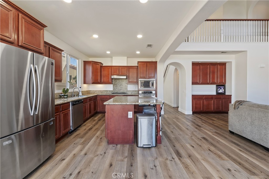 31244 Locust Court Temecula, CA 92592 - Photo 12 of 30 a kitchen with stainless steel appliances granite countertop a refrigerator a stove top oven a sink and dishwasher