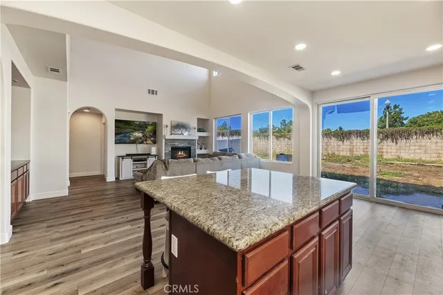 a kitchen with granite countertop kitchen island a stove and a table
