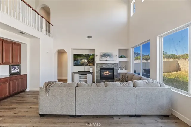 a living room with furniture a fireplace and a flat screen tv