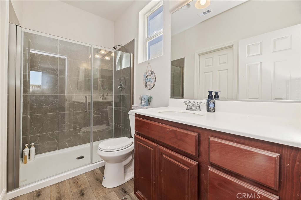 31244 Locust Court Temecula, CA 92592 - Photo 19 of 30 a bathroom with a sink a toilet and shower