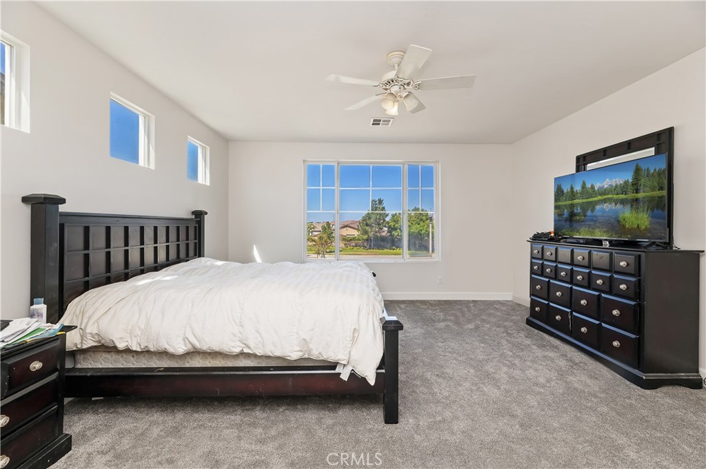 31244 Locust Court Temecula, CA 92592 - Photo 25 of 30 a bedroom with a bed and a flat tv screen on dresser