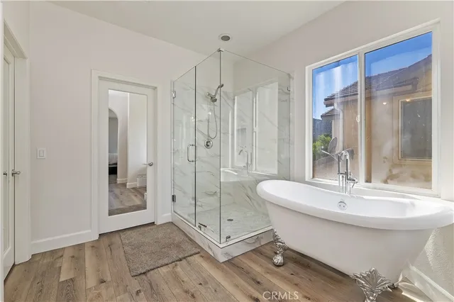 a spacious bathroom with a shower sink and mirror