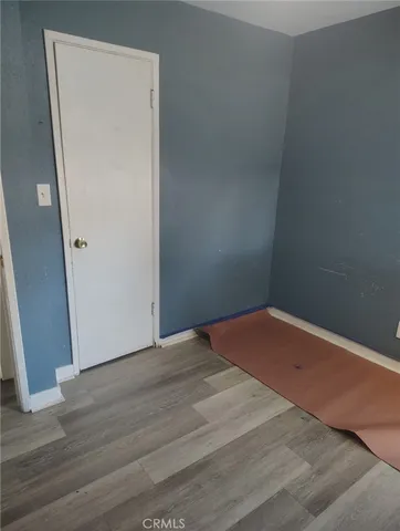 an empty room with wooden floor