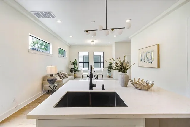 a room with wooden floor and lots of potted plant