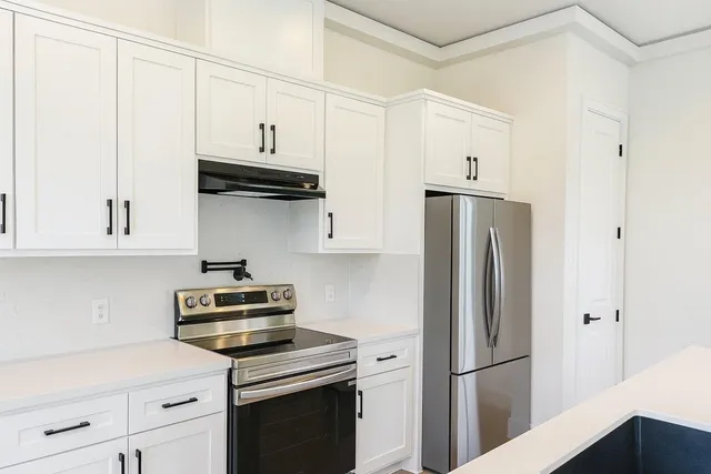a kitchen with stainless steel appliances a refrigerator stove and sink