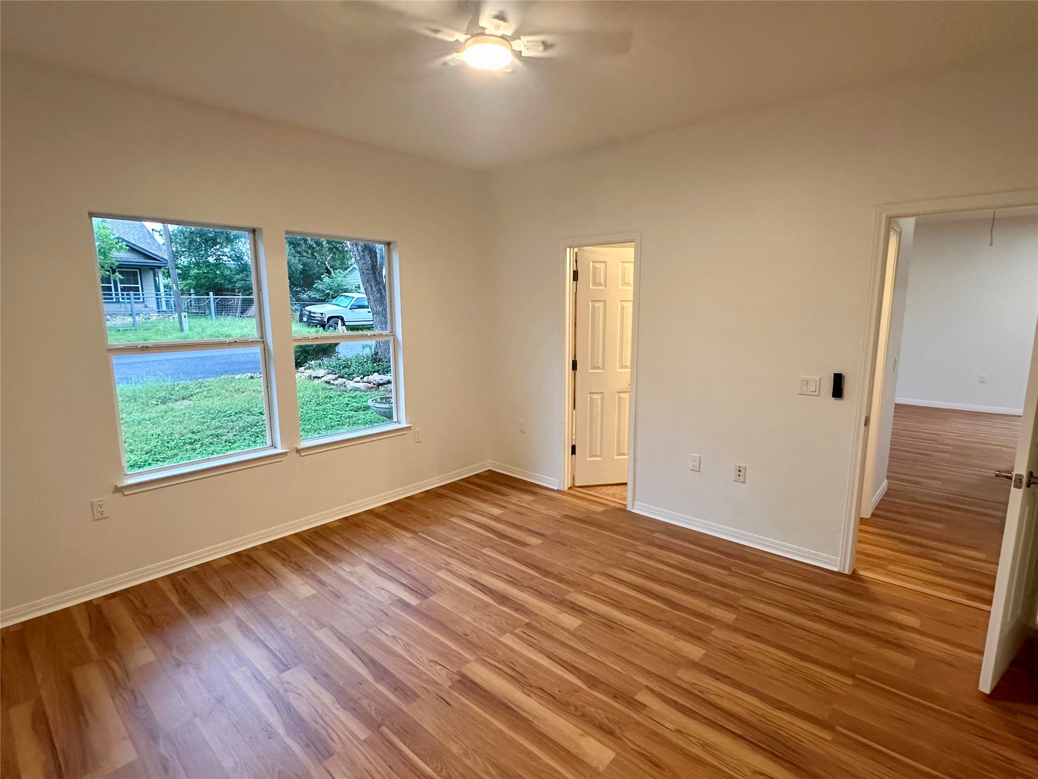1122 Mansell Avenue Austin, TX 78721 - Photo 19 of 29 a view of an empty room with wooden floor and a window