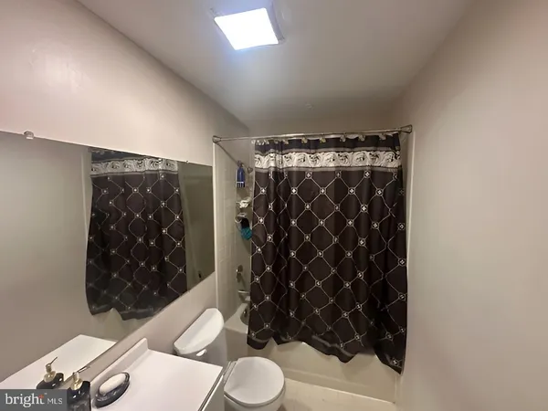 a bathroom with a black white toilet