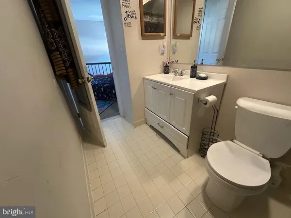 a bathroom with a sink toilet and mirror
