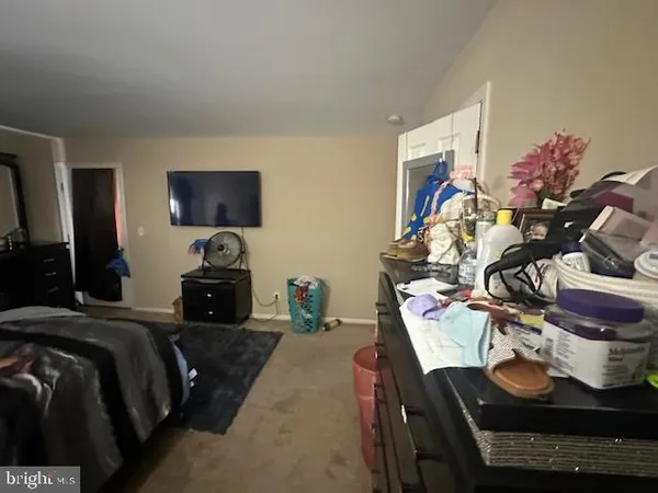 a bedroom with furniture and a flat screen tv
