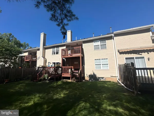 a view of a house with backyard and porch