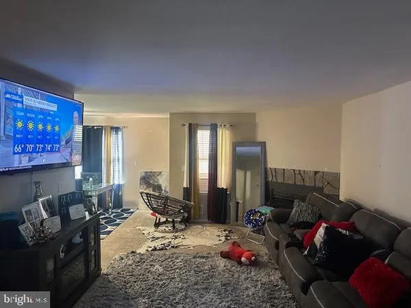a living room with furniture chess board and a window