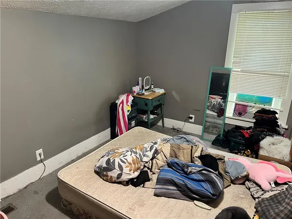 a bedroom with a bed and a tv