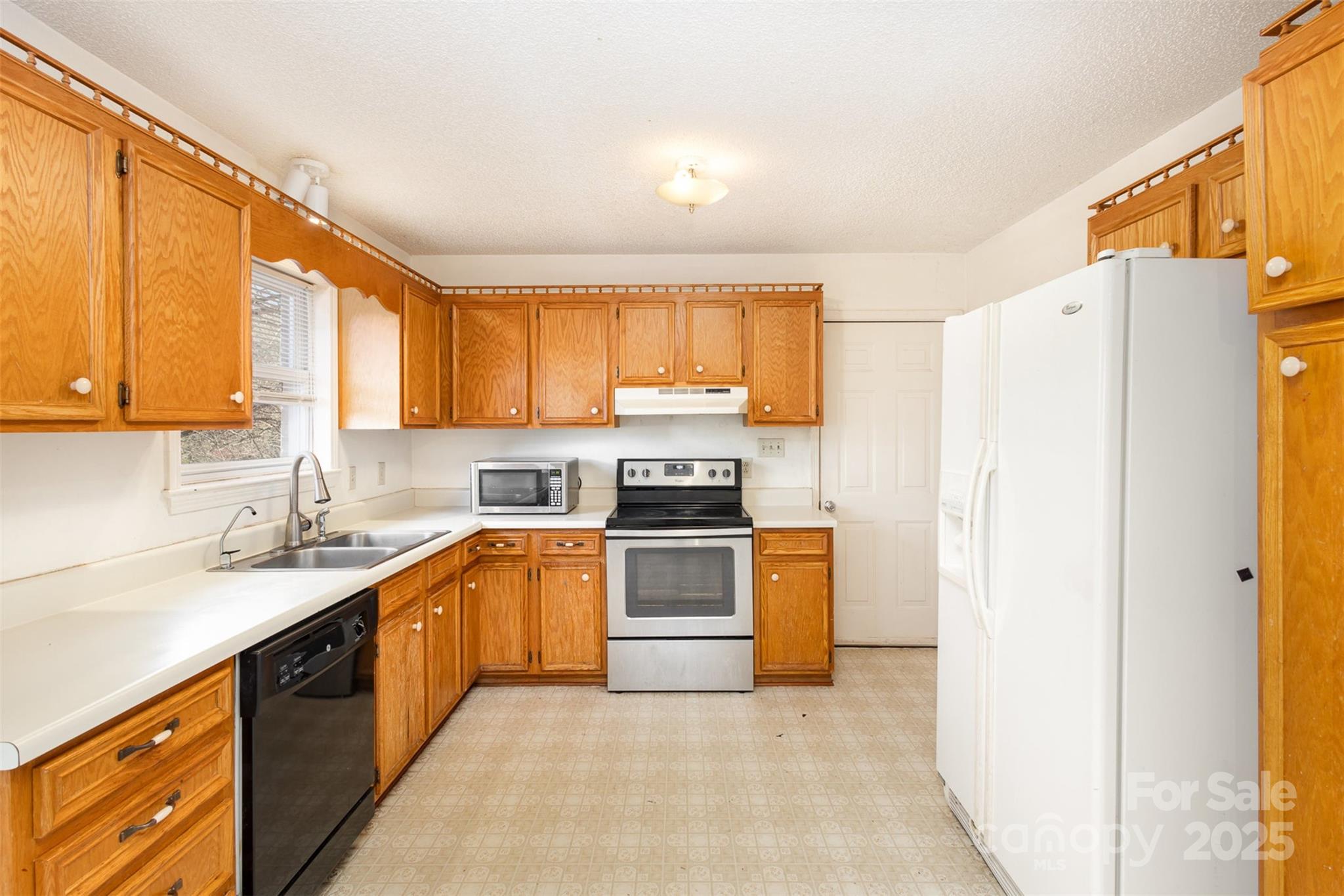 2888 Robinson Road Newton, NC 28658 - Photo 11 of 26 a kitchen with a refrigerator sink and cabinets