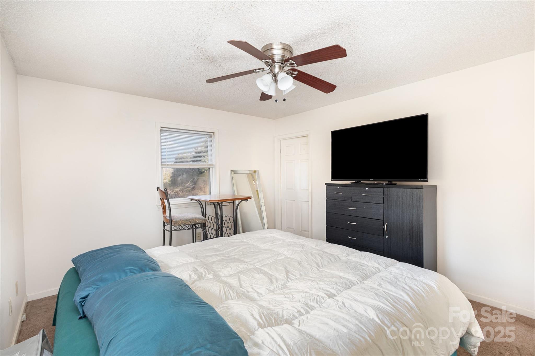 2888 Robinson Road Newton, NC 28658 - Photo 16 of 26 a bedroom with a bed and a flat screen tv