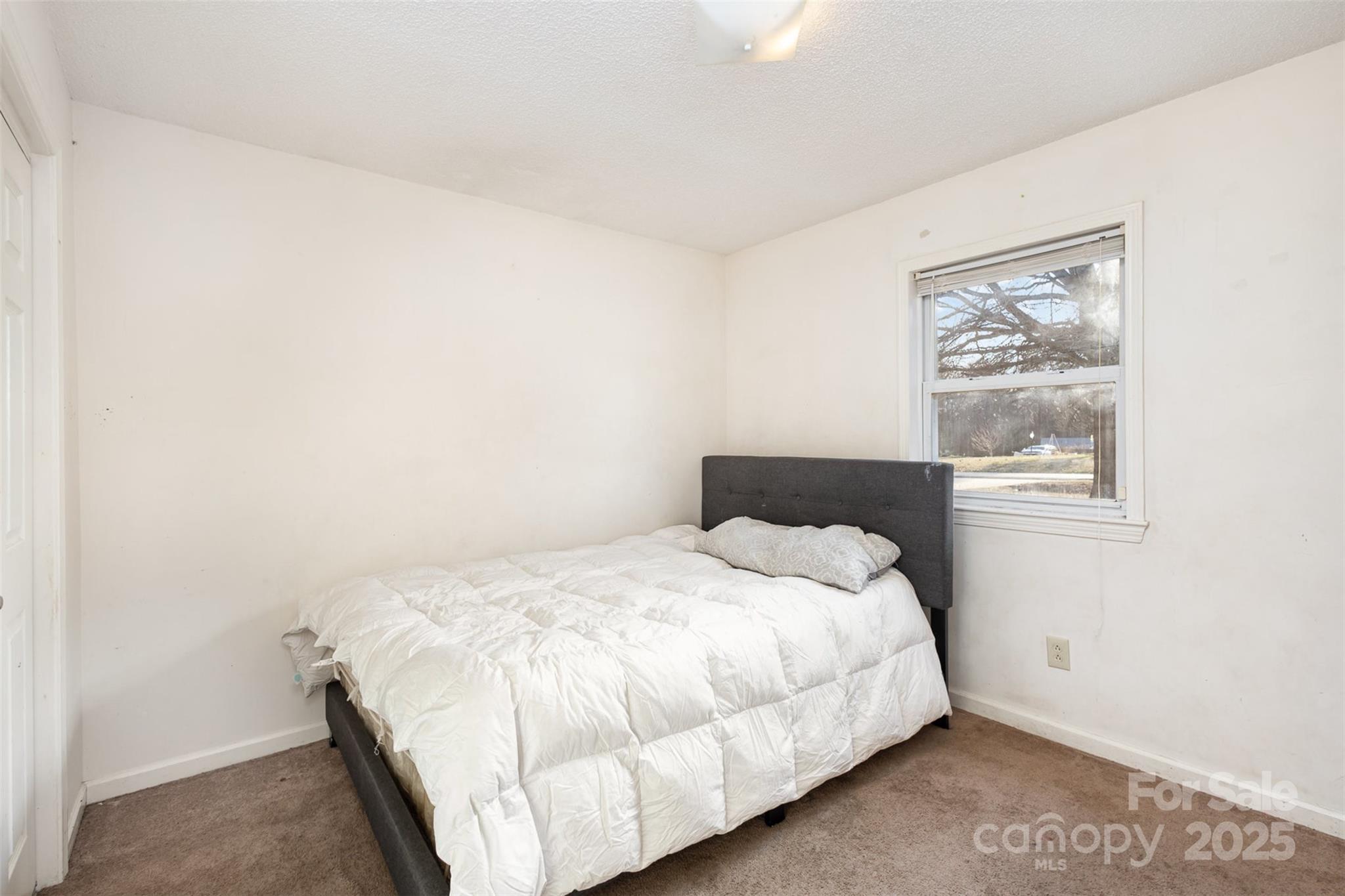 2888 Robinson Road Newton, NC 28658 - Photo 19 of 26 a bedroom with a bed and a window