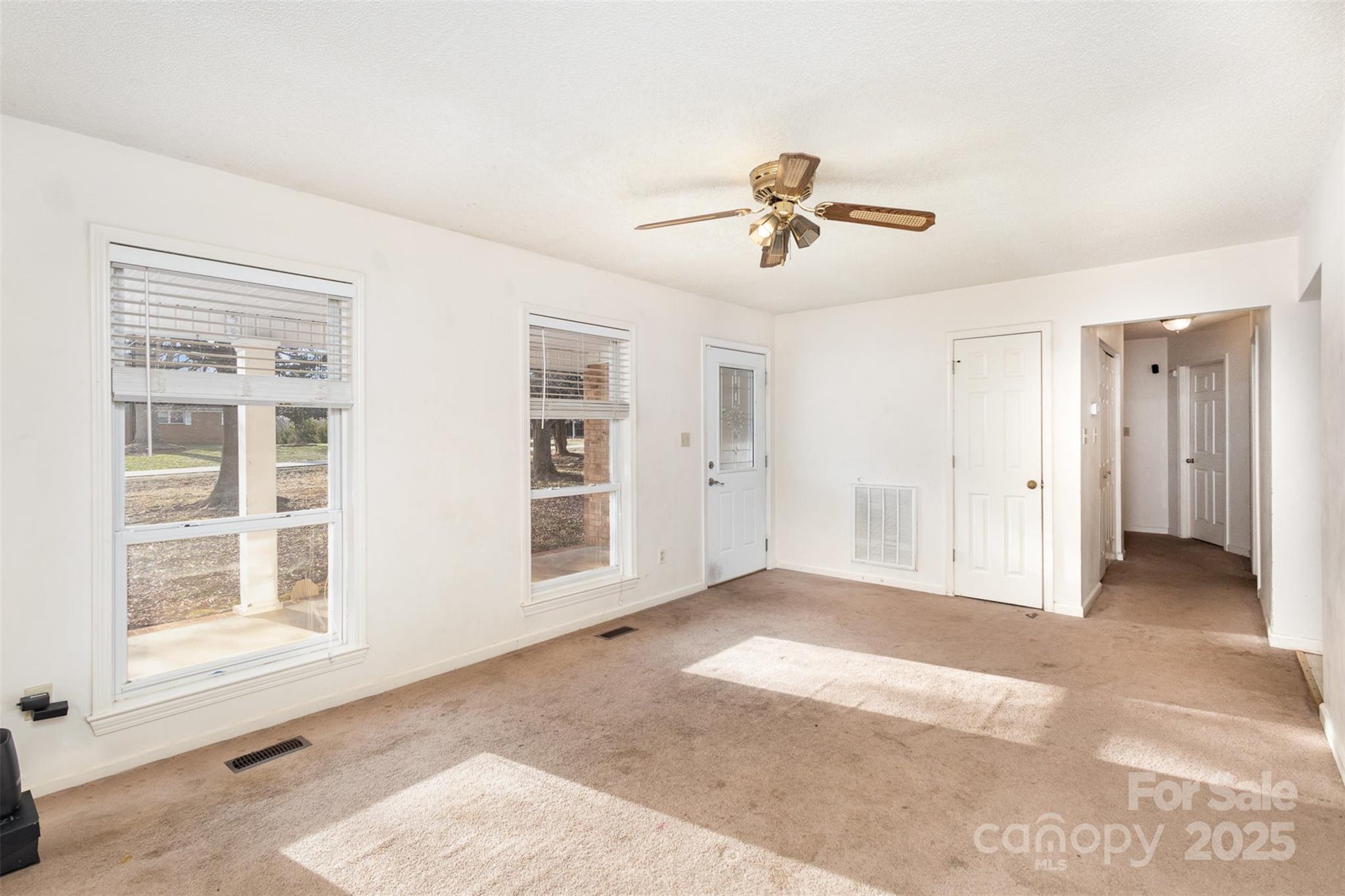 2888 Robinson Road Newton, NC 28658 - Photo 7 of 26 a view of a livingroom with a ceiling fan and window