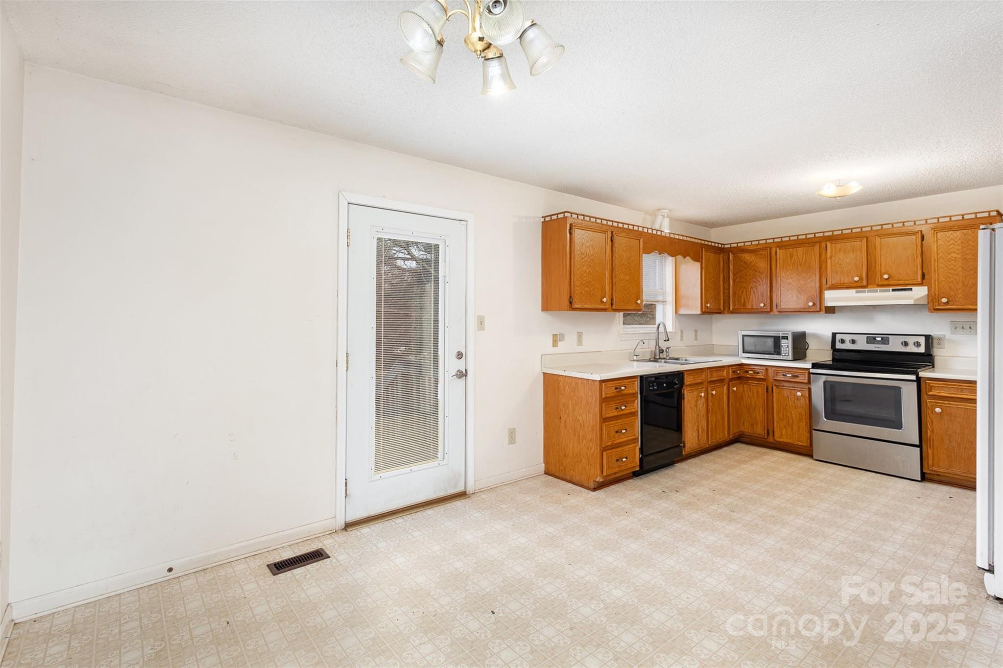 2888 Robinson Road Newton, NC 28658 - Photo 9 of 26 a large kitchen with stainless steel appliances granite countertop a stove a sink dishwasher and a refrigerator