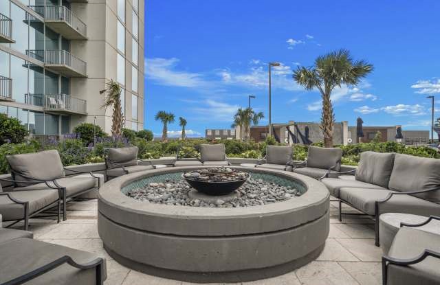 5925 Almeda Road, Unit 12308 Houston, TX 77004 - Photo 37 of 48 a view of a swimming pool with a couches chairs and potted plants