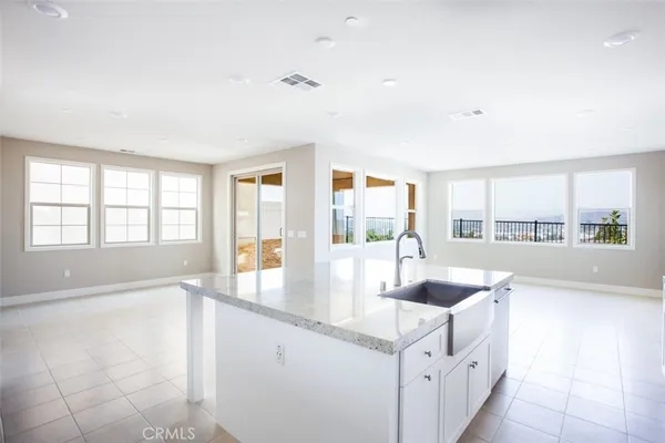a kitchen with counter top space and windows