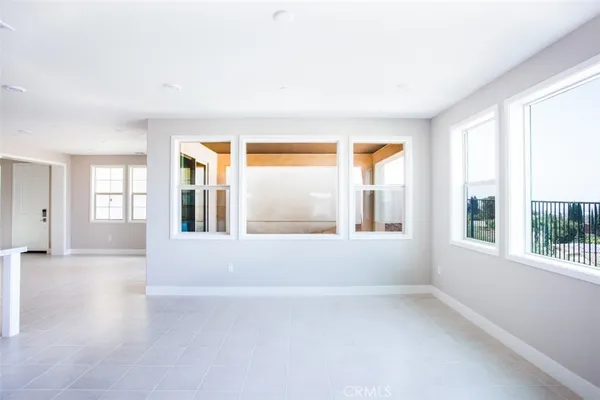 an empty room with windows and outdoor view