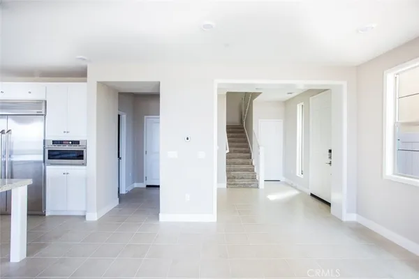 a view of a kitchen with refrigerator and more cabinets