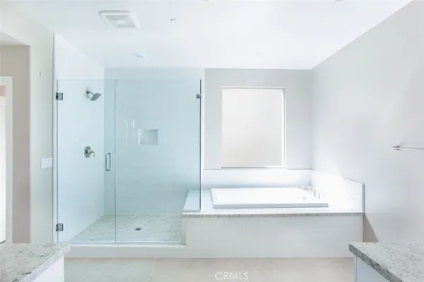 a bathroom with a bathtub and shower