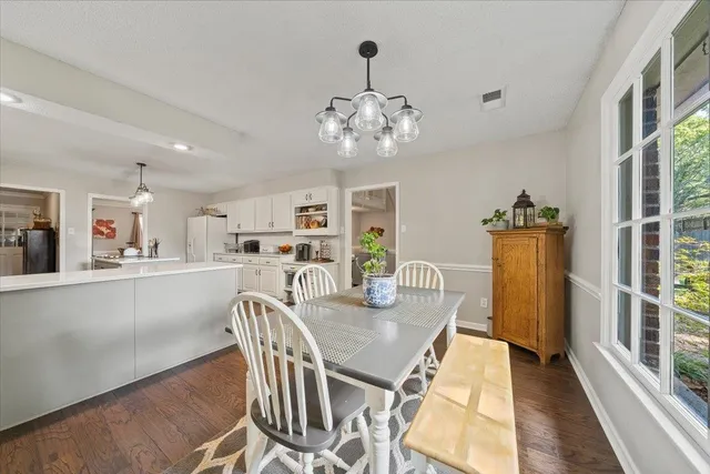 a view of a dining room with furniture and wooden floor