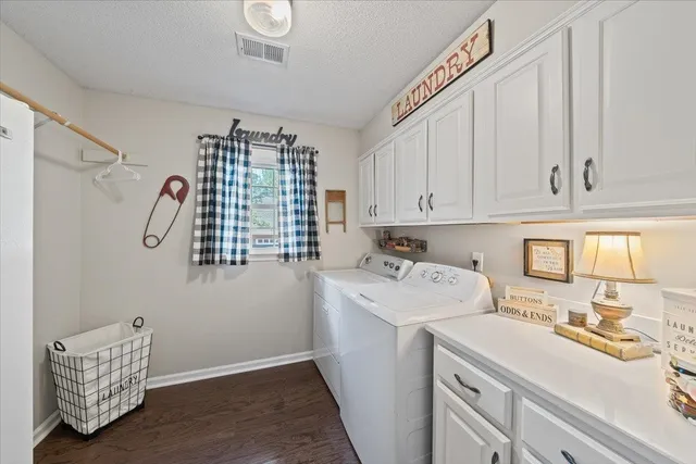a utility room with sink dryer and washer