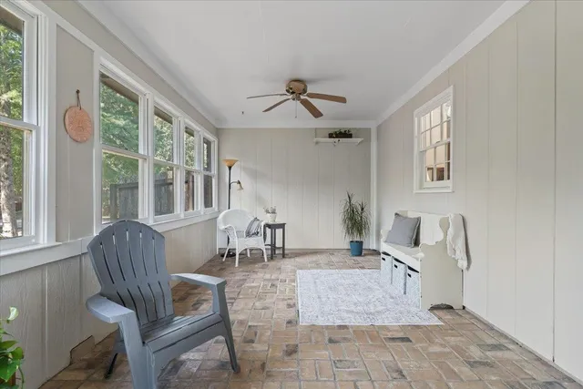 a living room with furniture and large windows