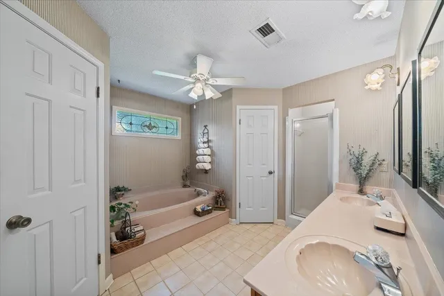 a spacious bedroom with a bed and a chandelier