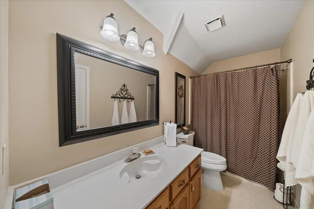 a bathroom with a sink a light fixture and a mirror