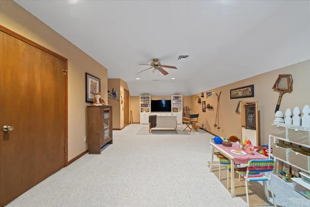 a view of a livingroom with furniture and a ceiling fan