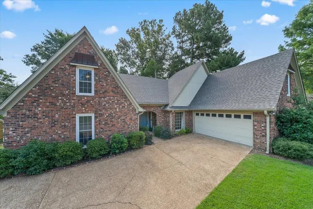 a view of a house with a yard and garage