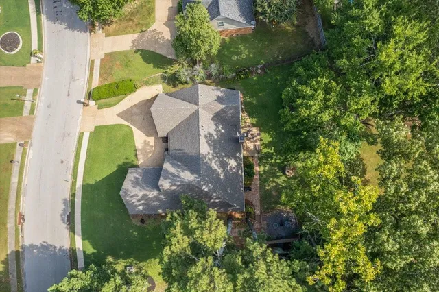 an aerial view of a house with a yard and garden