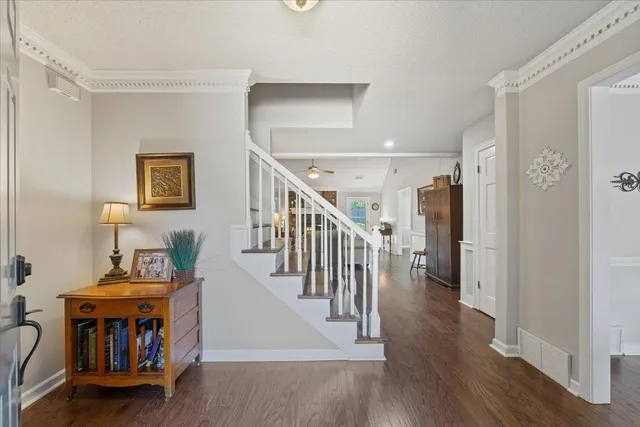 a view of front door with dining room and wooden floor