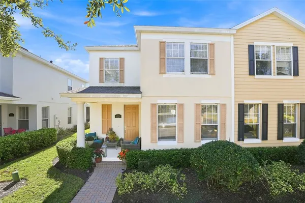 front view of a brick house with a yard