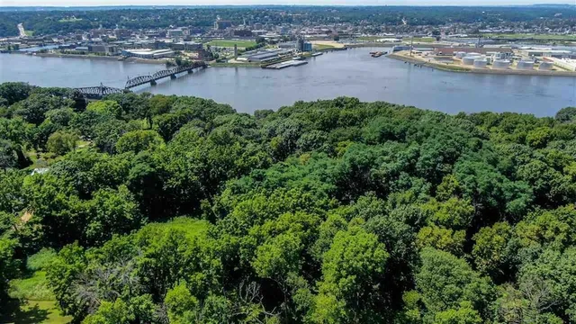 an aerial view of residential houses with outdoor space and lake view
