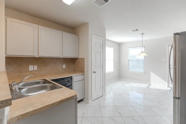 a kitchen that has a sink and a stove