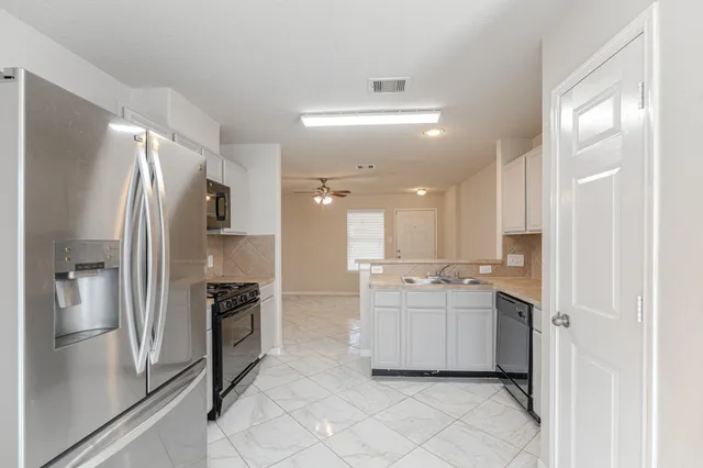 a kitchen with a refrigerator and a sink