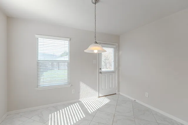 a view of an empty room with a window