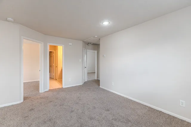 a view of an empty room and a window