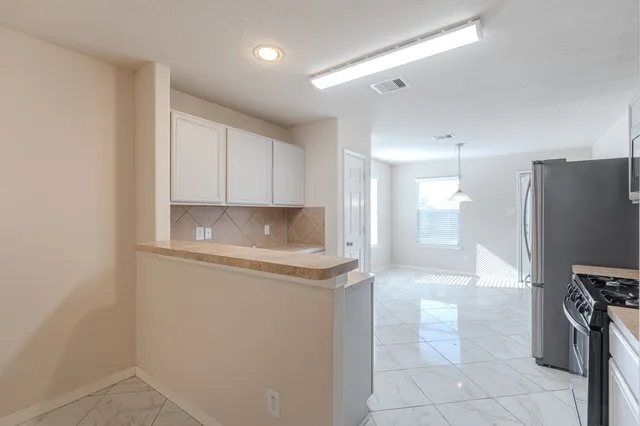 a kitchen with stainless steel appliances a refrigerator and a stove